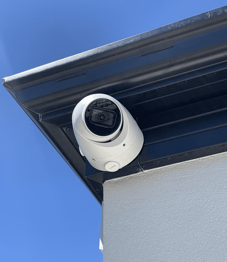 image (31) CCTV camera mounted on a building corner under a clear blue sky, emphasizing security surveillance for homes and businesses in Perth, WA.