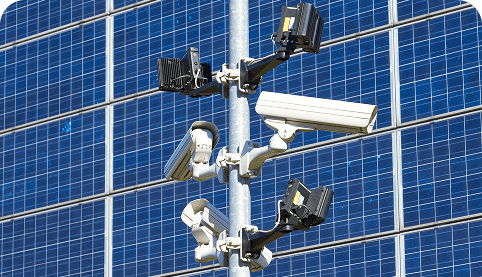 image (34) Solar-powered 4G CCTV cameras mounted on a pole against a backdrop of solar panels, emphasizing renewable energy solutions for security in remote locations.